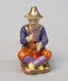 Флакон в виде играющего на тарелках китайца